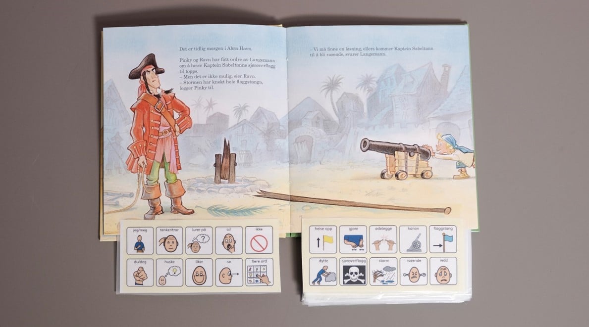 Barnebok der det er limt på remser med grafiske symboler